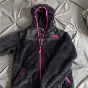 gray and pink fluffy north face jacket